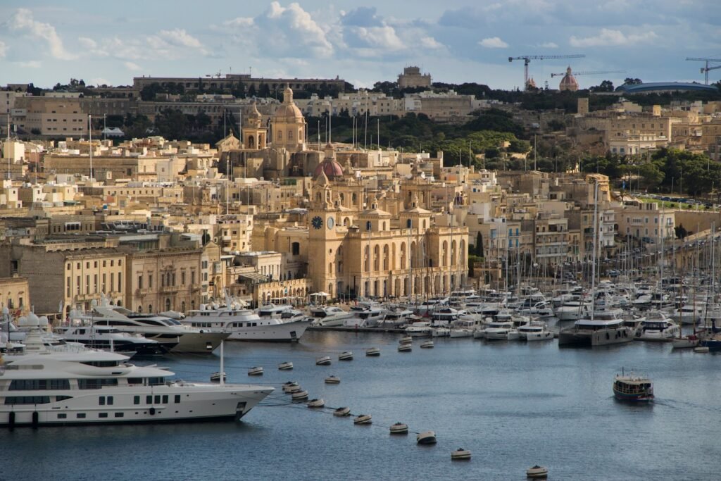 a harbor filled with lots of boats next to a city Malta must-visit