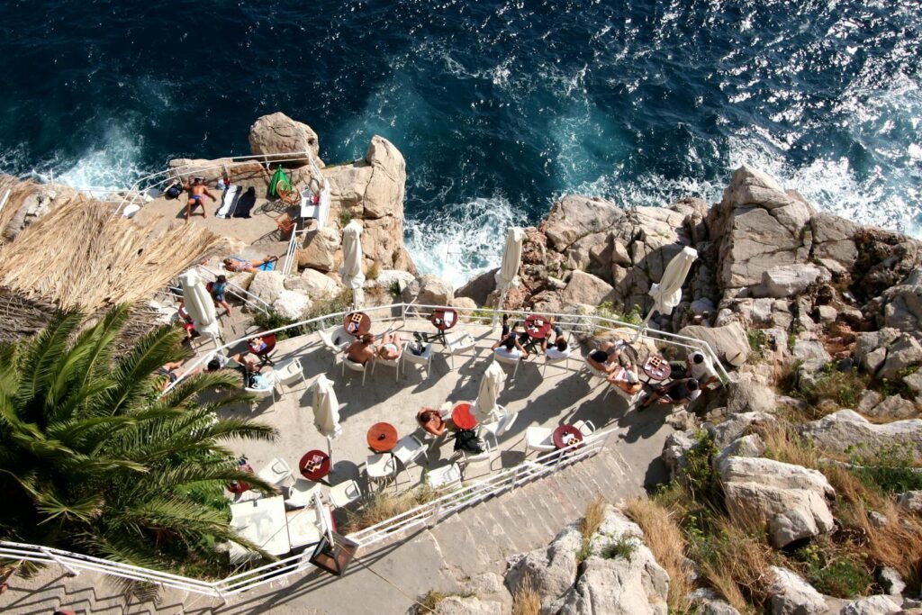 Tourists on the Terraces of the Buza Bar on the Seaside Cliff of Dubrovnik