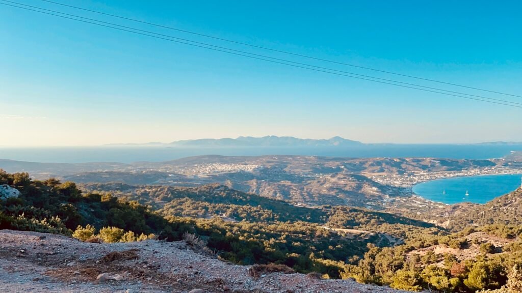 green trees and mountains under blue sky during daytime