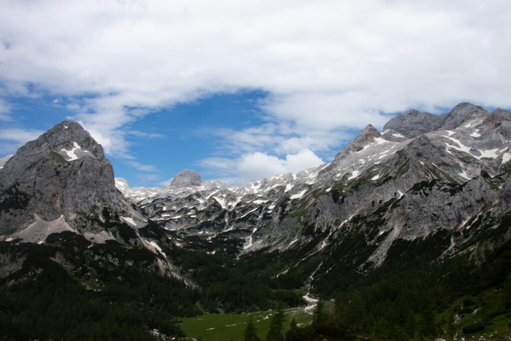 green and white mountains under blue sky and white clouds during daytime