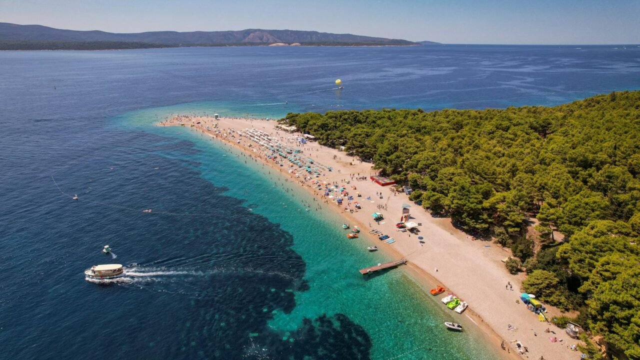 The beach in croatia with boats and people