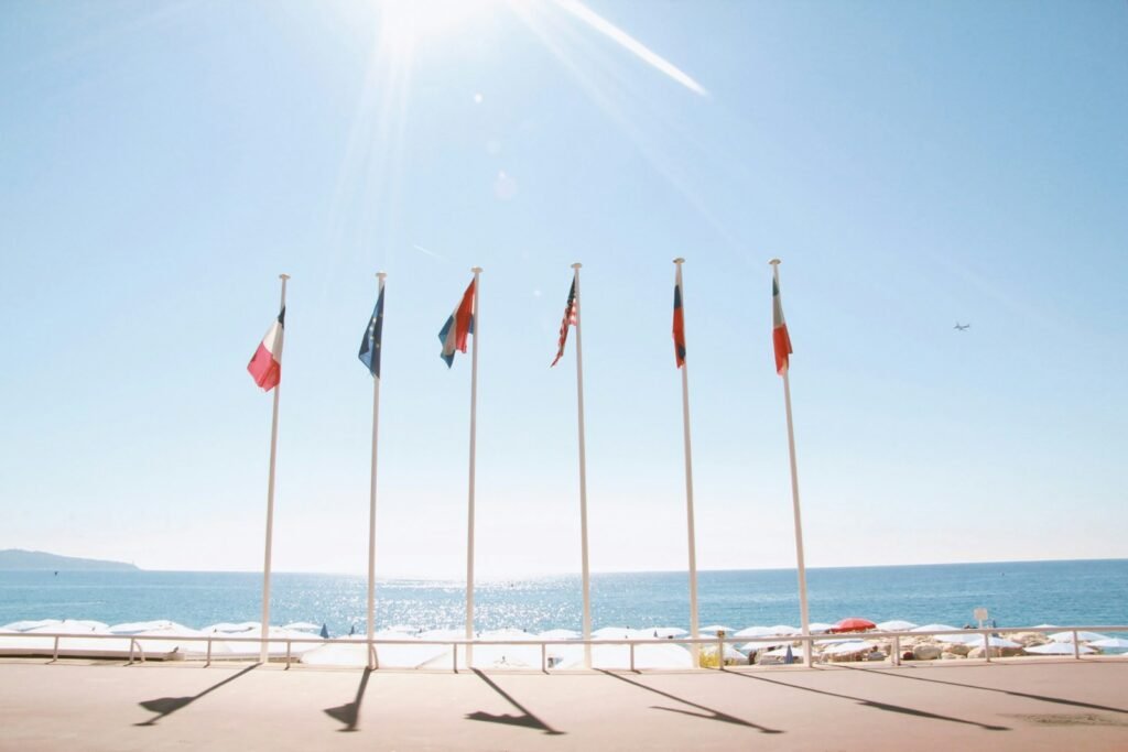 six assorted country flags beside body of water