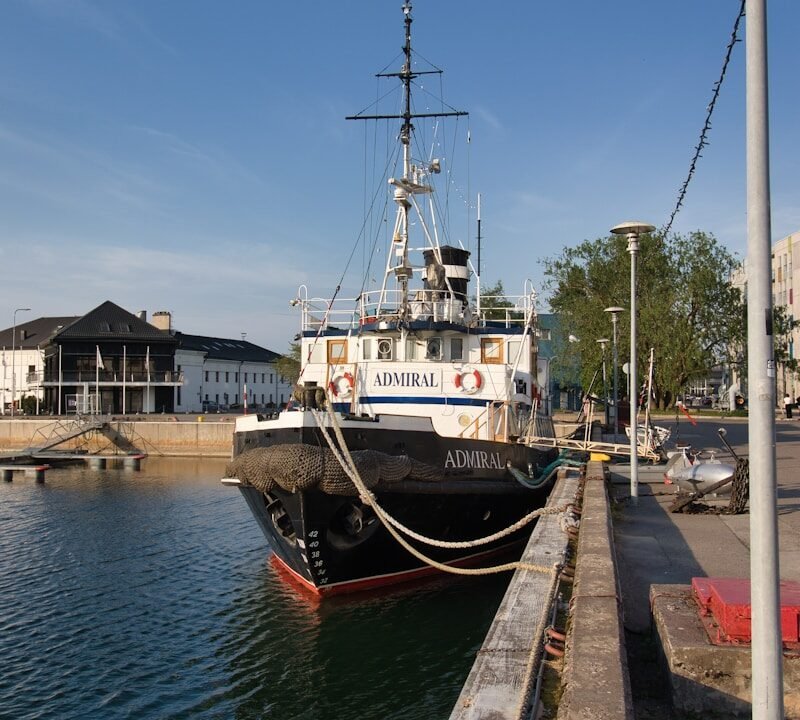 A boat docked at a dock in the water