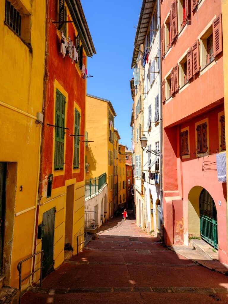 A narrow city street lined with tall buildings